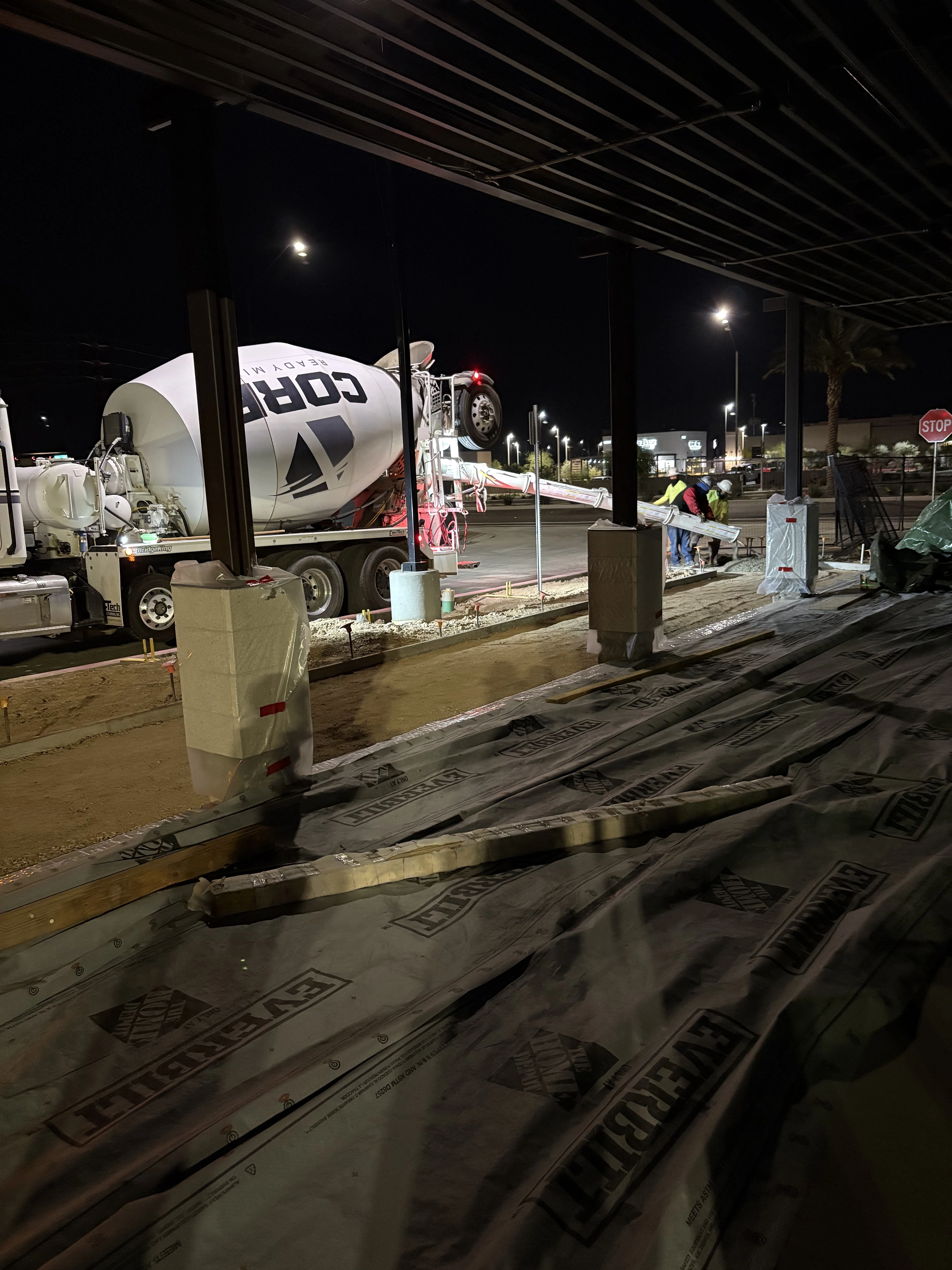 Commercial concrete contractor pouring sidewalk at night in Phoenix Arizona